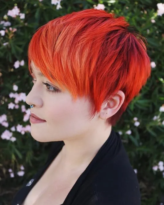 Bright orange-red pixie with darker roots