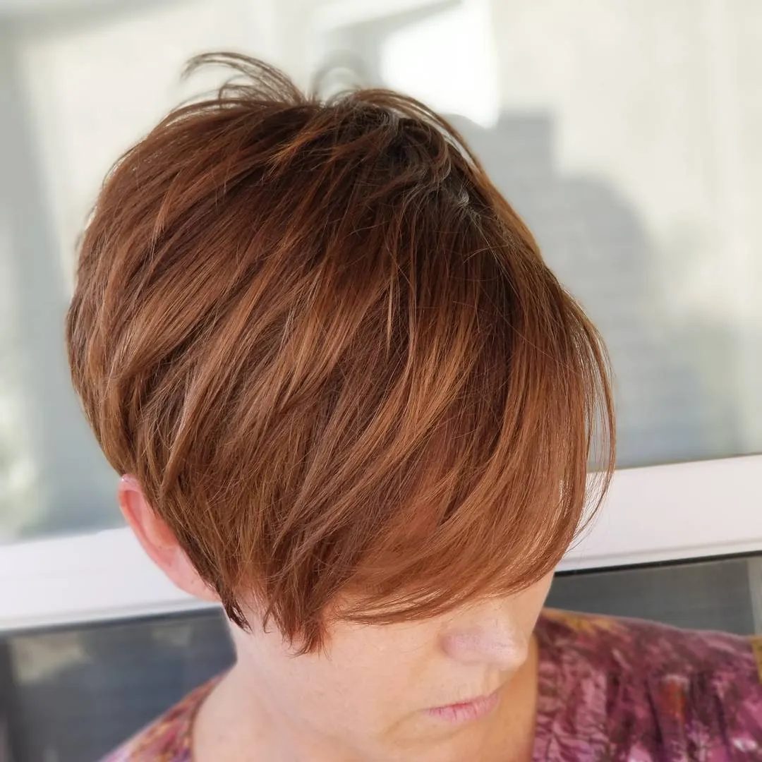 Warm copper-brown side-swept textured pixie
