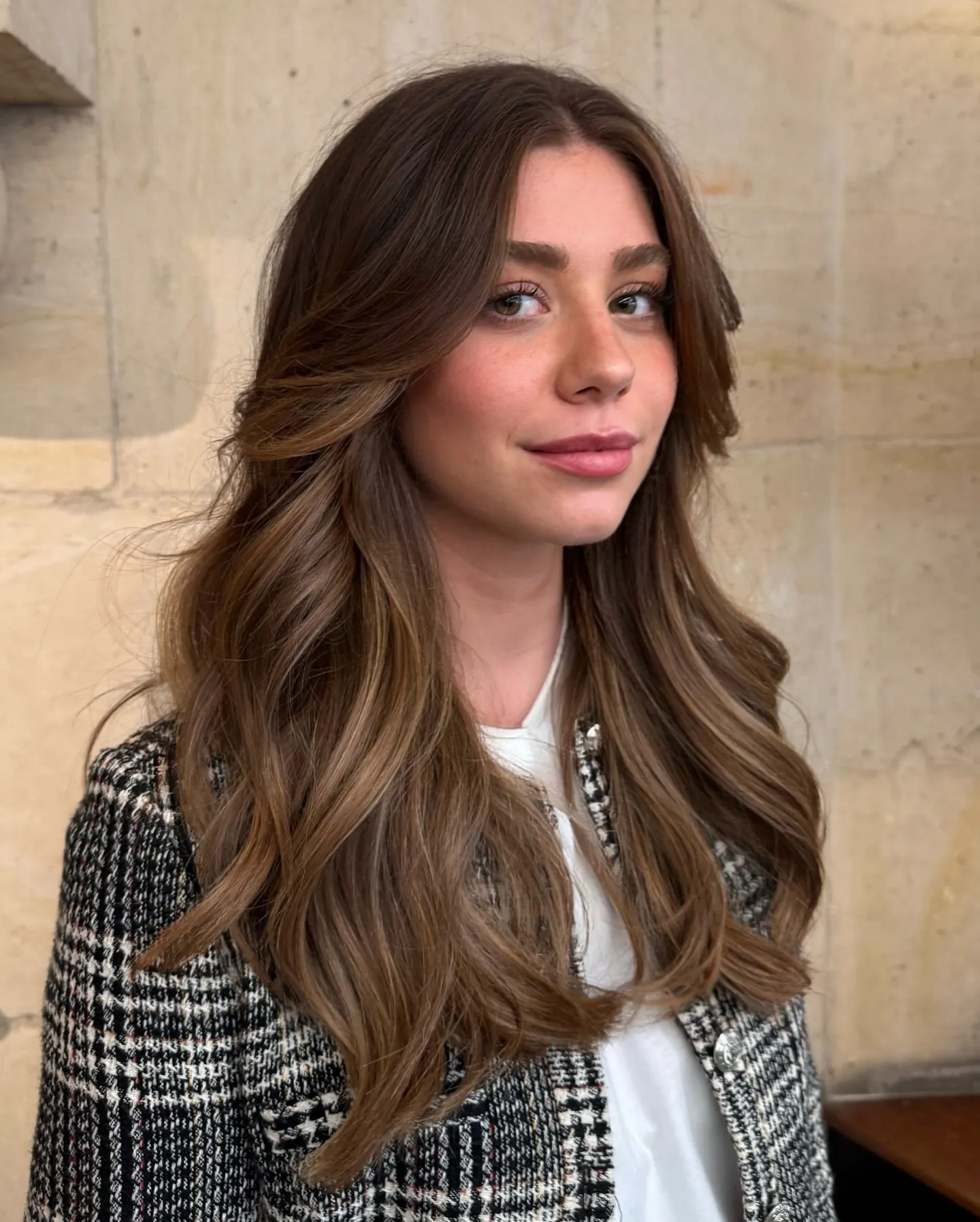 Long brown hair with face-framing layers and soft waves