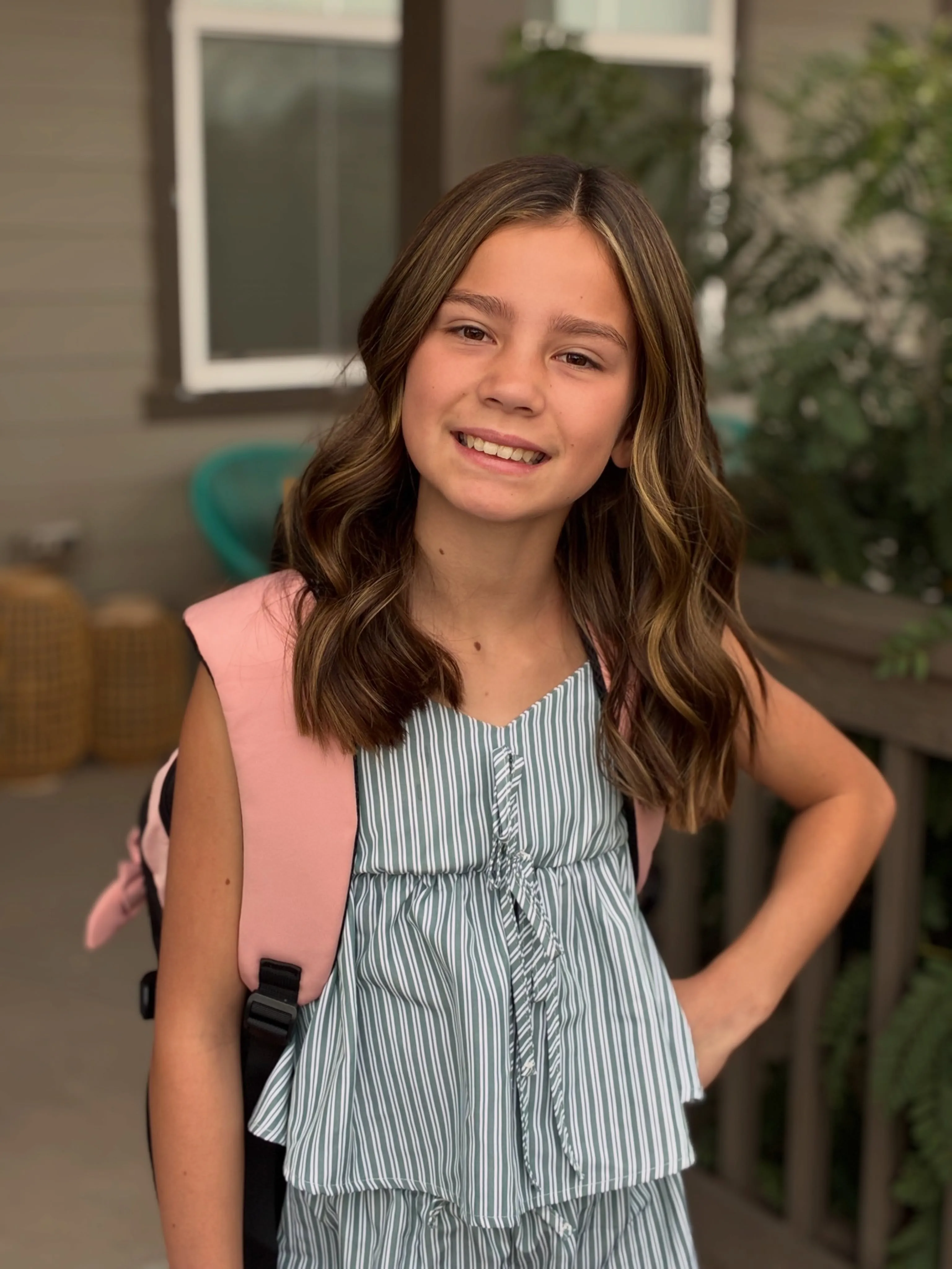 Shoulder-length brown hair with a center part and soft waves