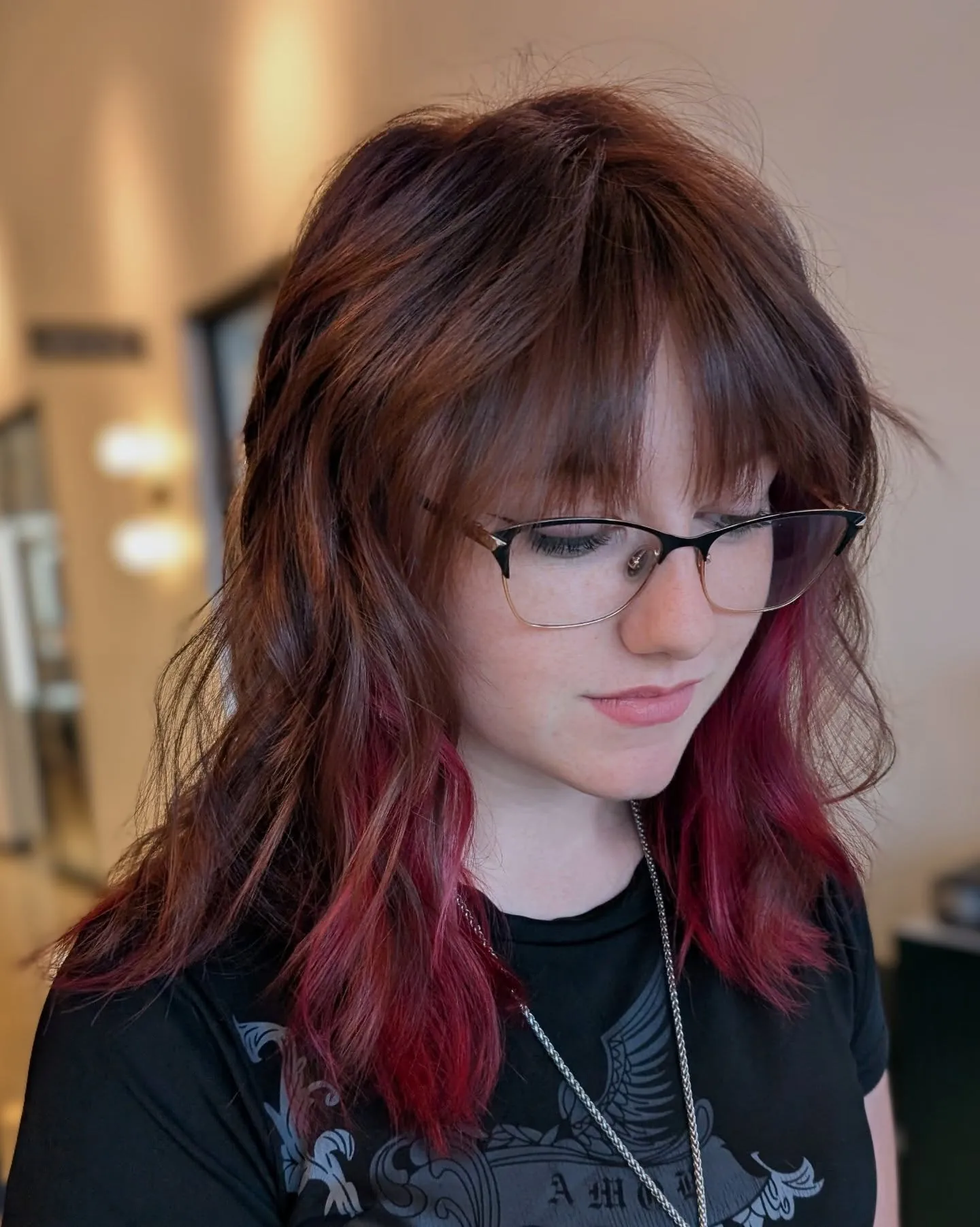 Layered shoulder-length shag with full bangs and bright red lower sections