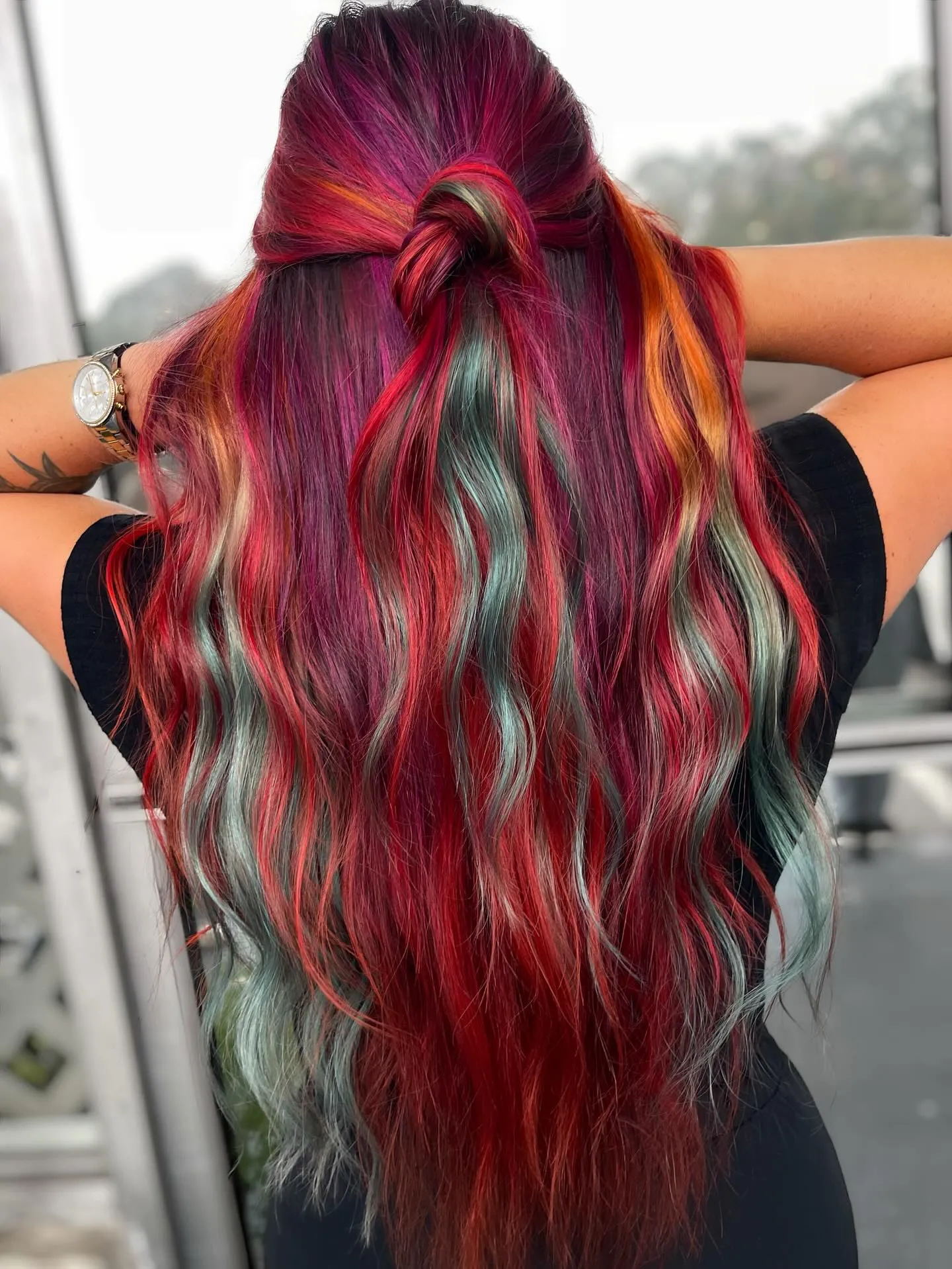Long half-up waves with red, orange, magenta and teal streaks