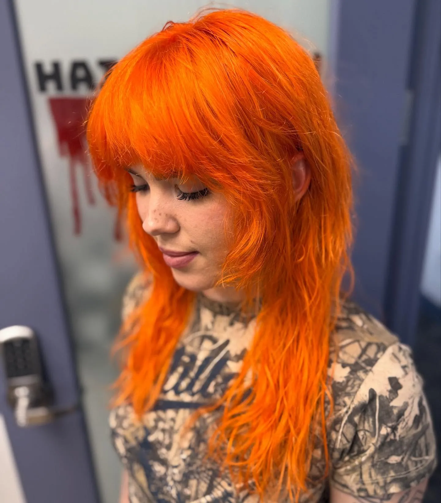 Bright orange shag haircut with full fringe and textured layers