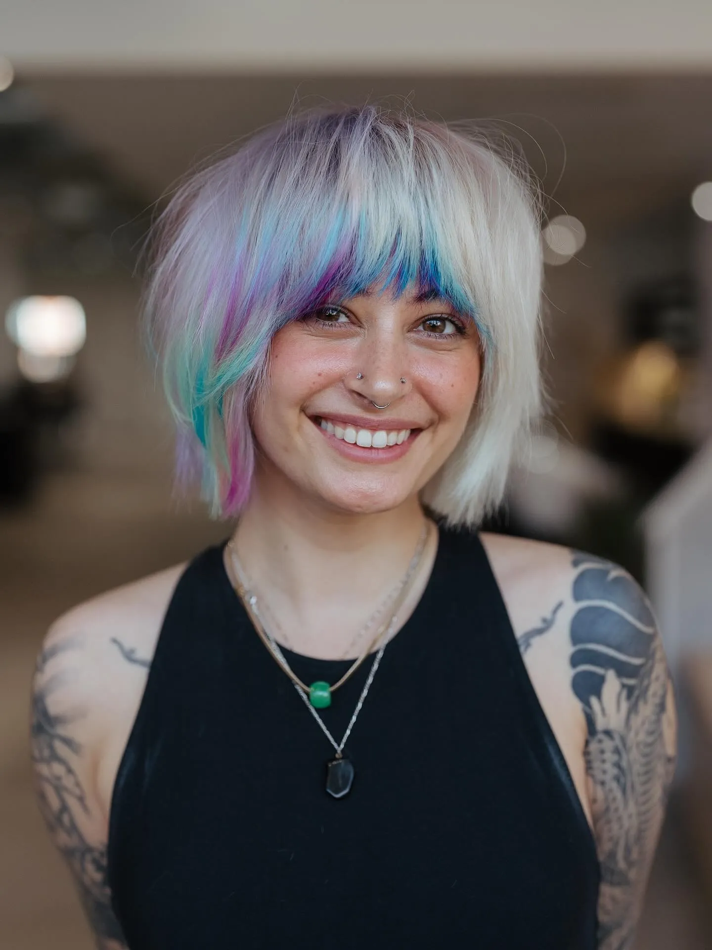 White blunt bob with soft blue, lilac and pink colour through the fringe