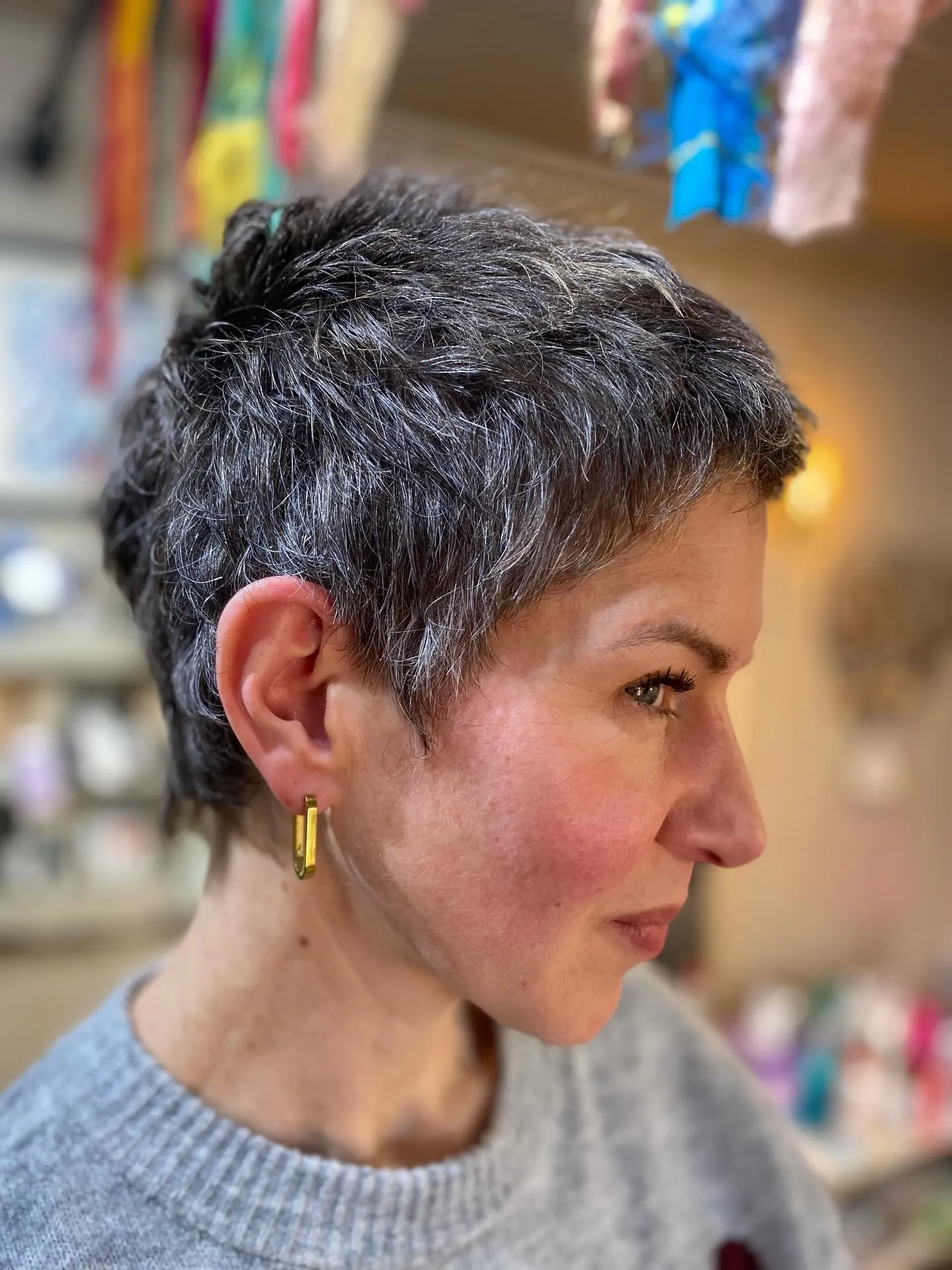 Textured grey pixie with short piecey layers and tapered sides