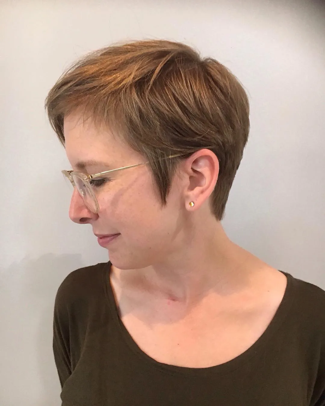 Classic feathered pixie with soft crown layers and tapered sideburns
