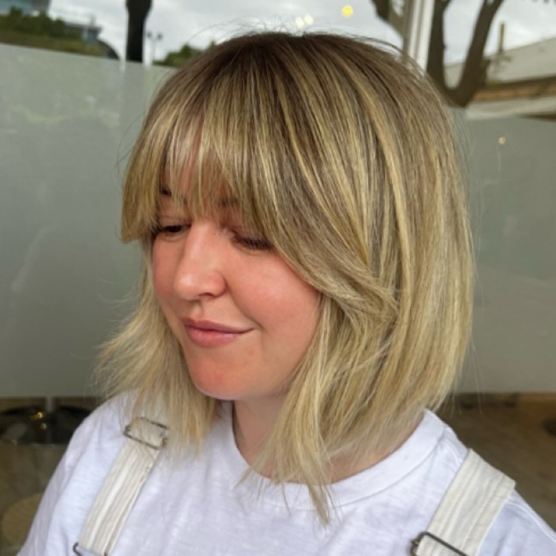 shoulder-length shag haircut with a full fringe