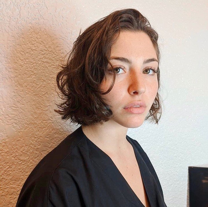 chin-length wavy bob with a deep side part
