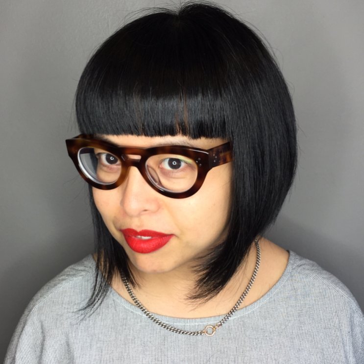 sleek angled bob haircut with a blunt full fringe