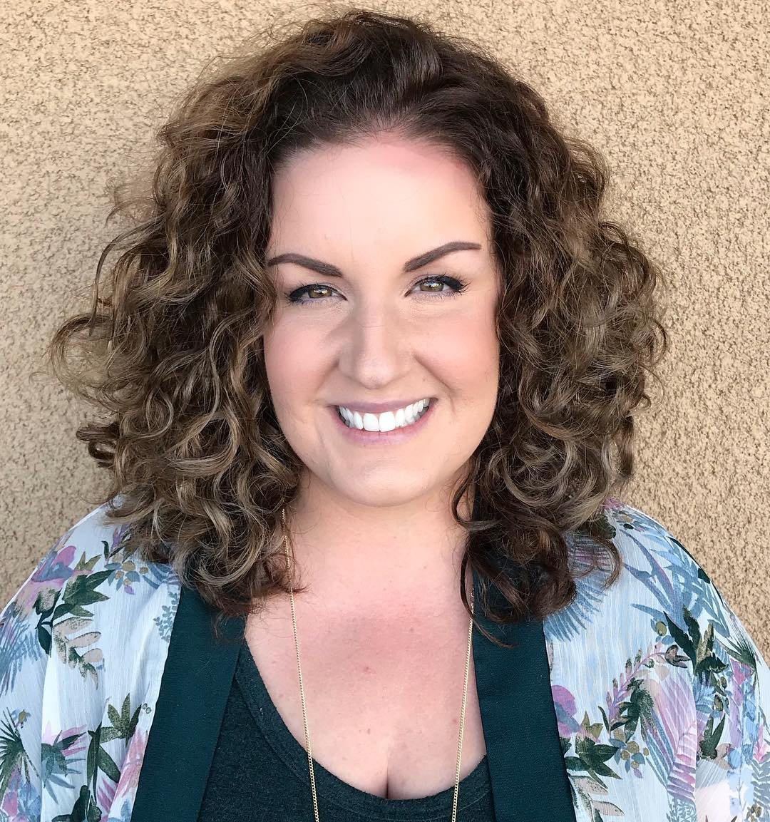 layered shoulder-length curly haircut with rounded volume