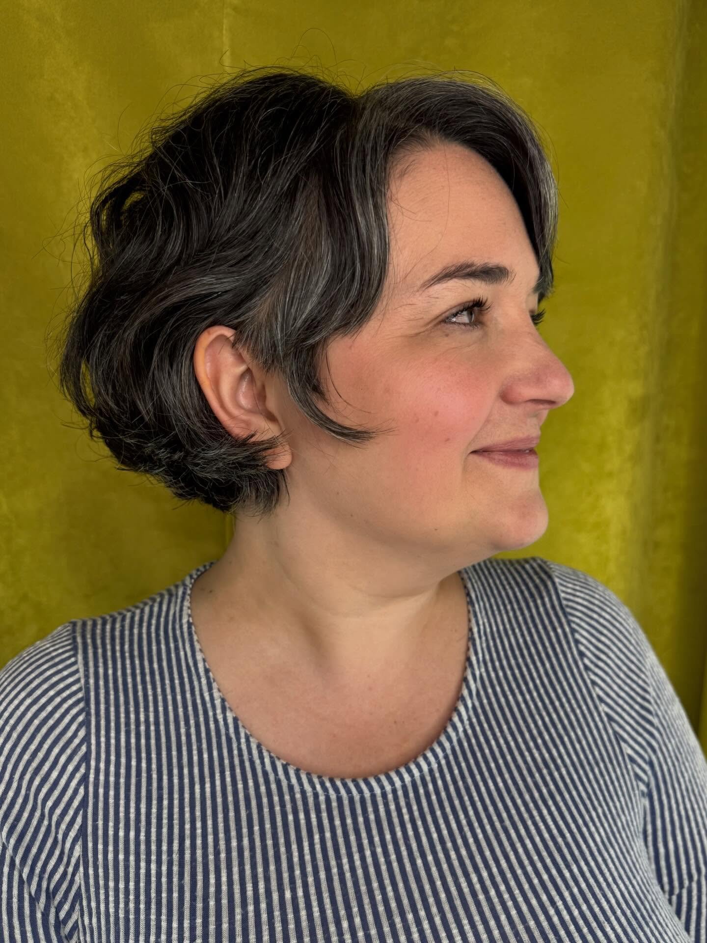 short wavy bob with a centre part and tucked sides