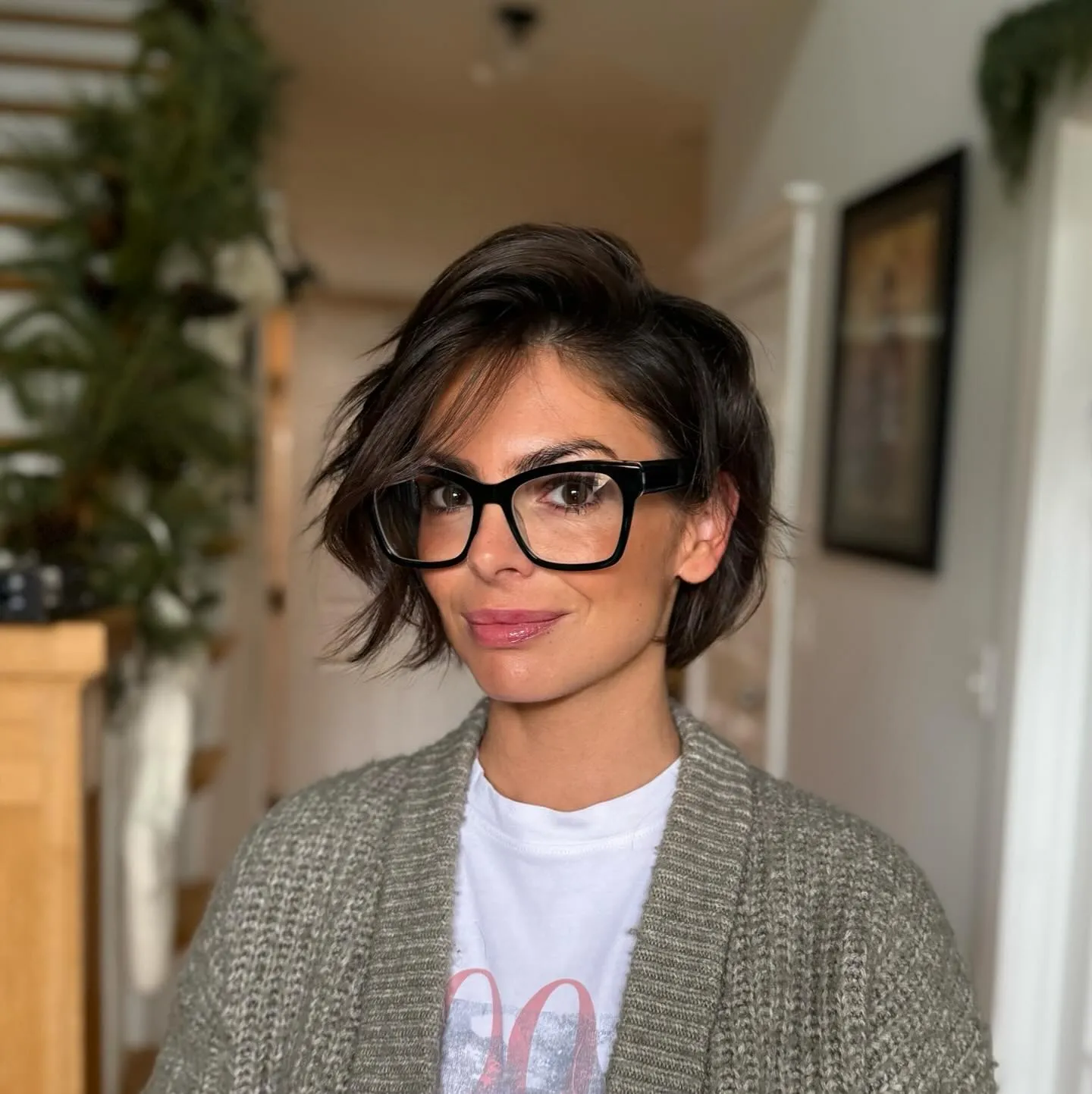 Asymmetrical wavy short bob with a deep side part and tucked side