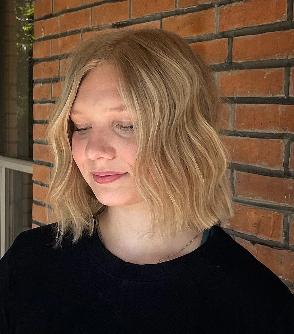 Soft blonde wavy short bob with a relaxed centre part
