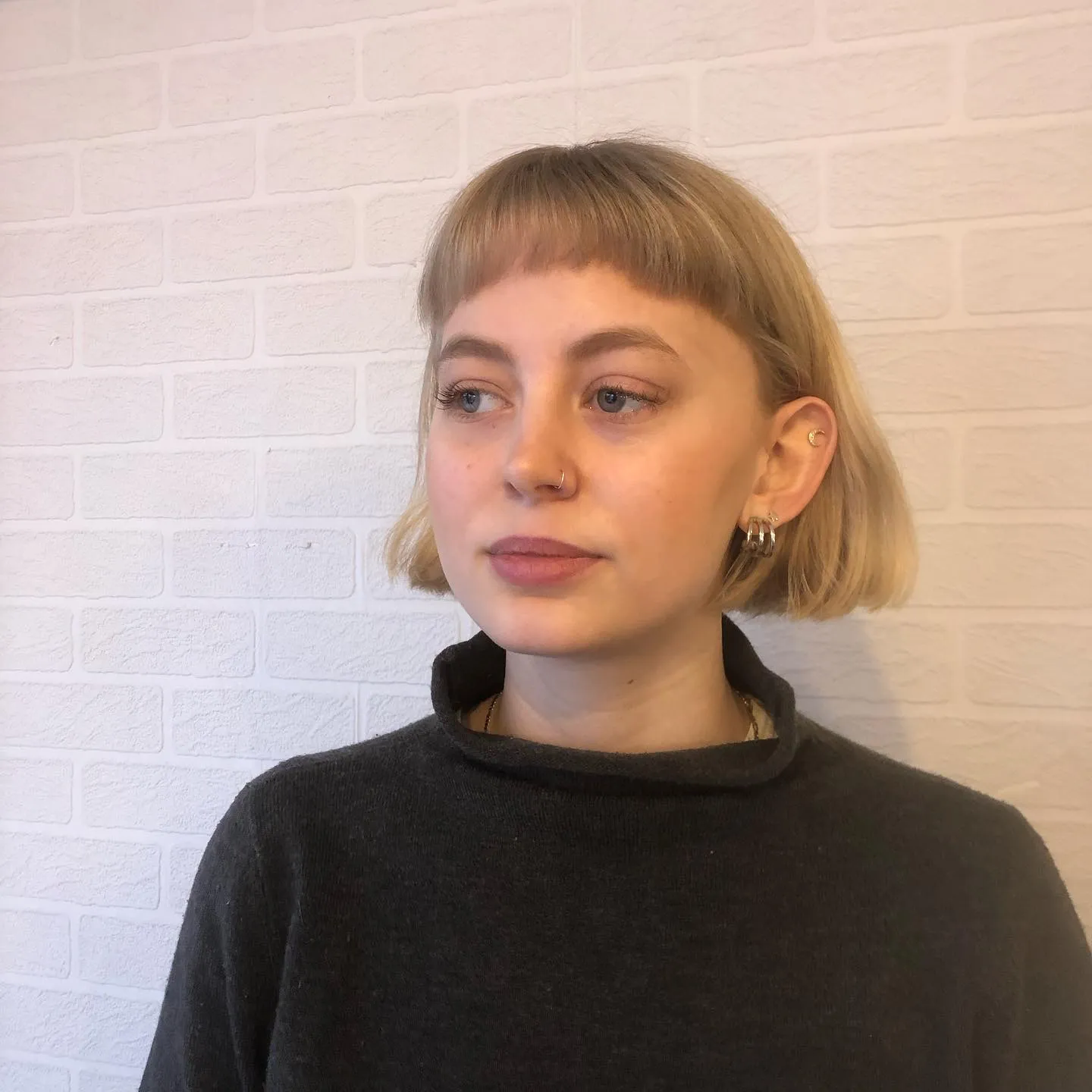 Short mini bob with a blunt micro fringe and tucked sides