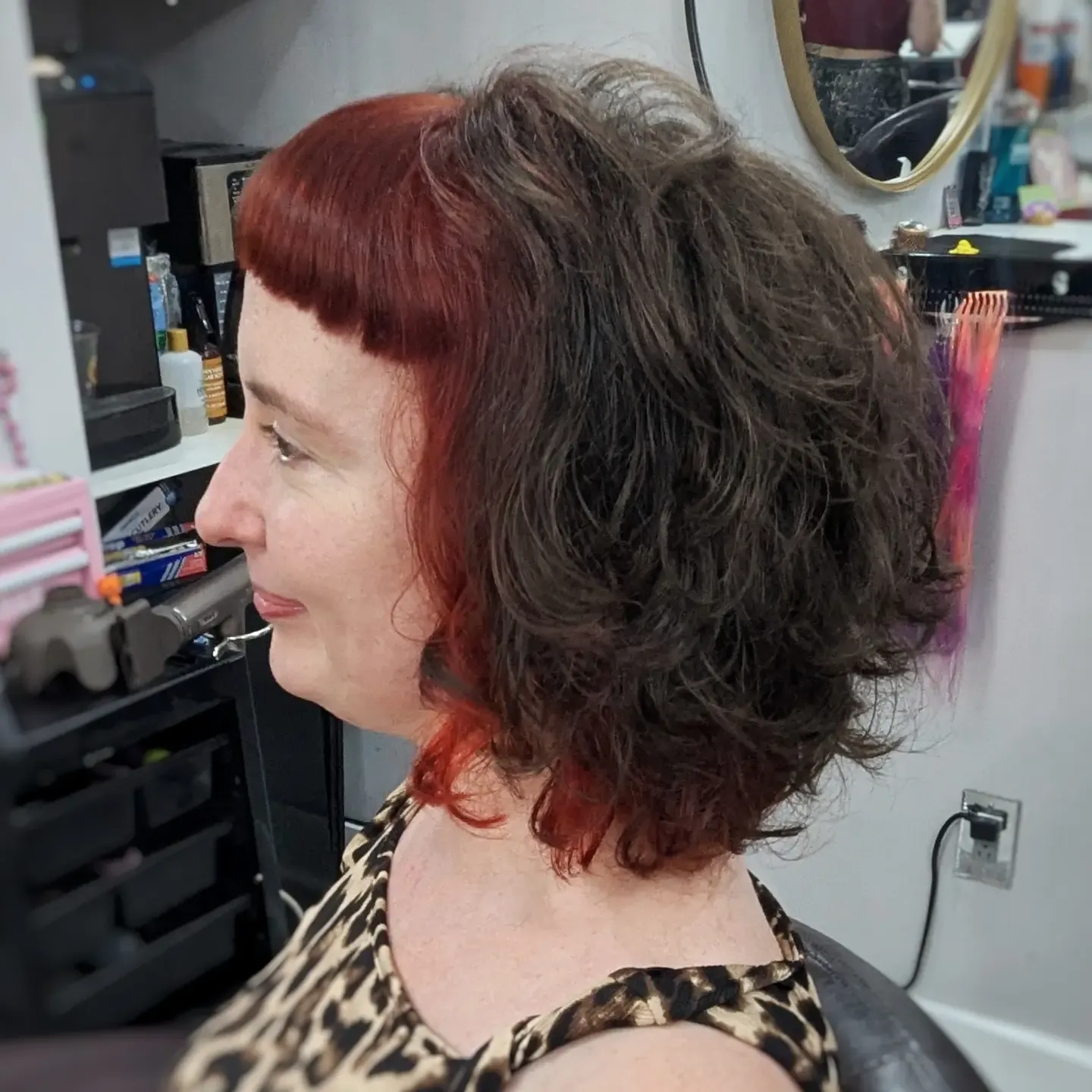 Two-tone curly bob with red fringe and dark volume