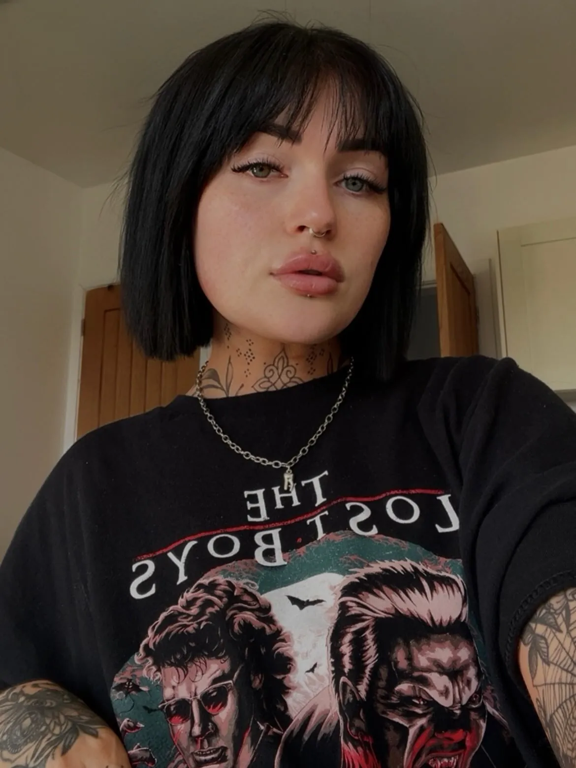 Sleek black chin-length bob with soft full fringe