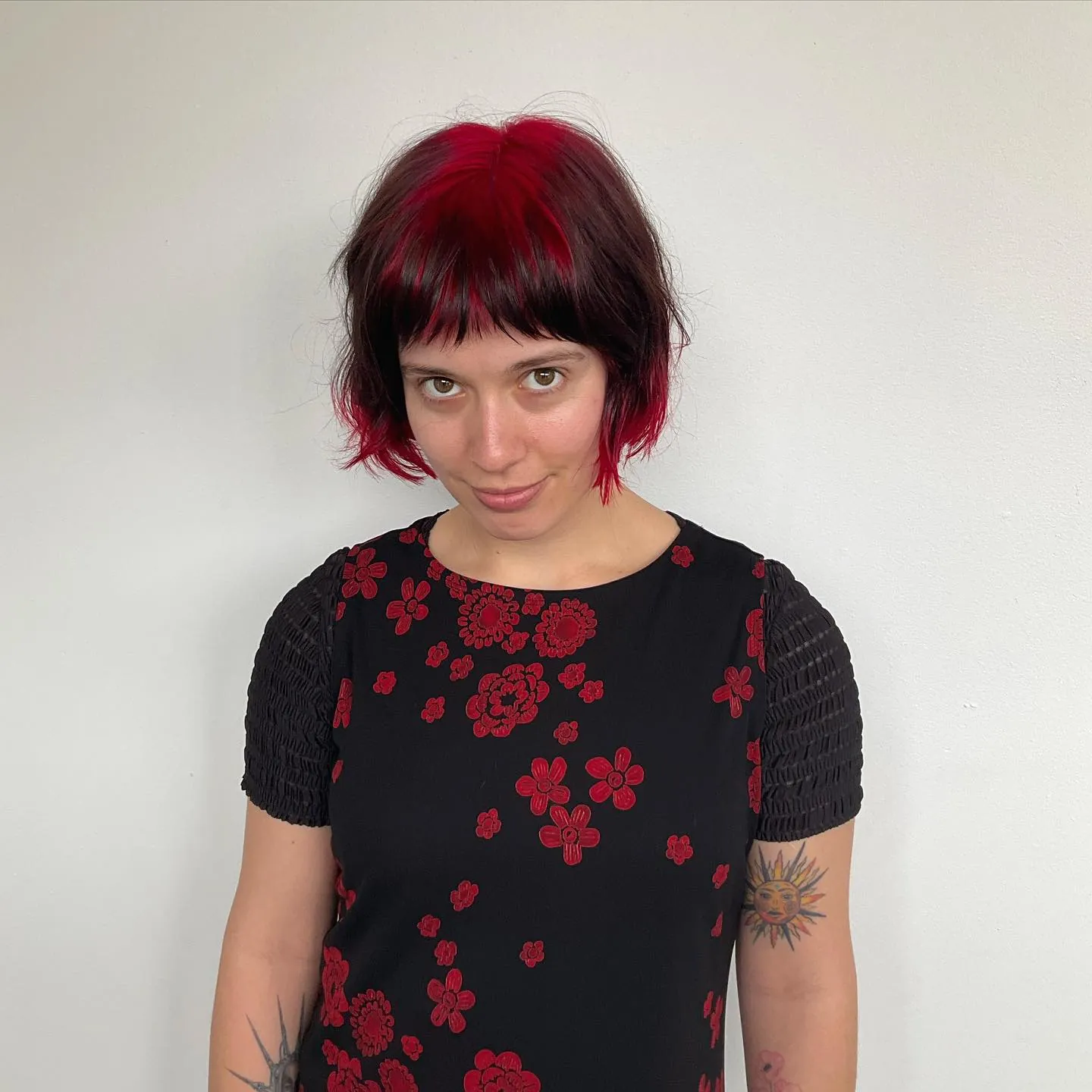 Dark layered bob with red crown and flicked ends