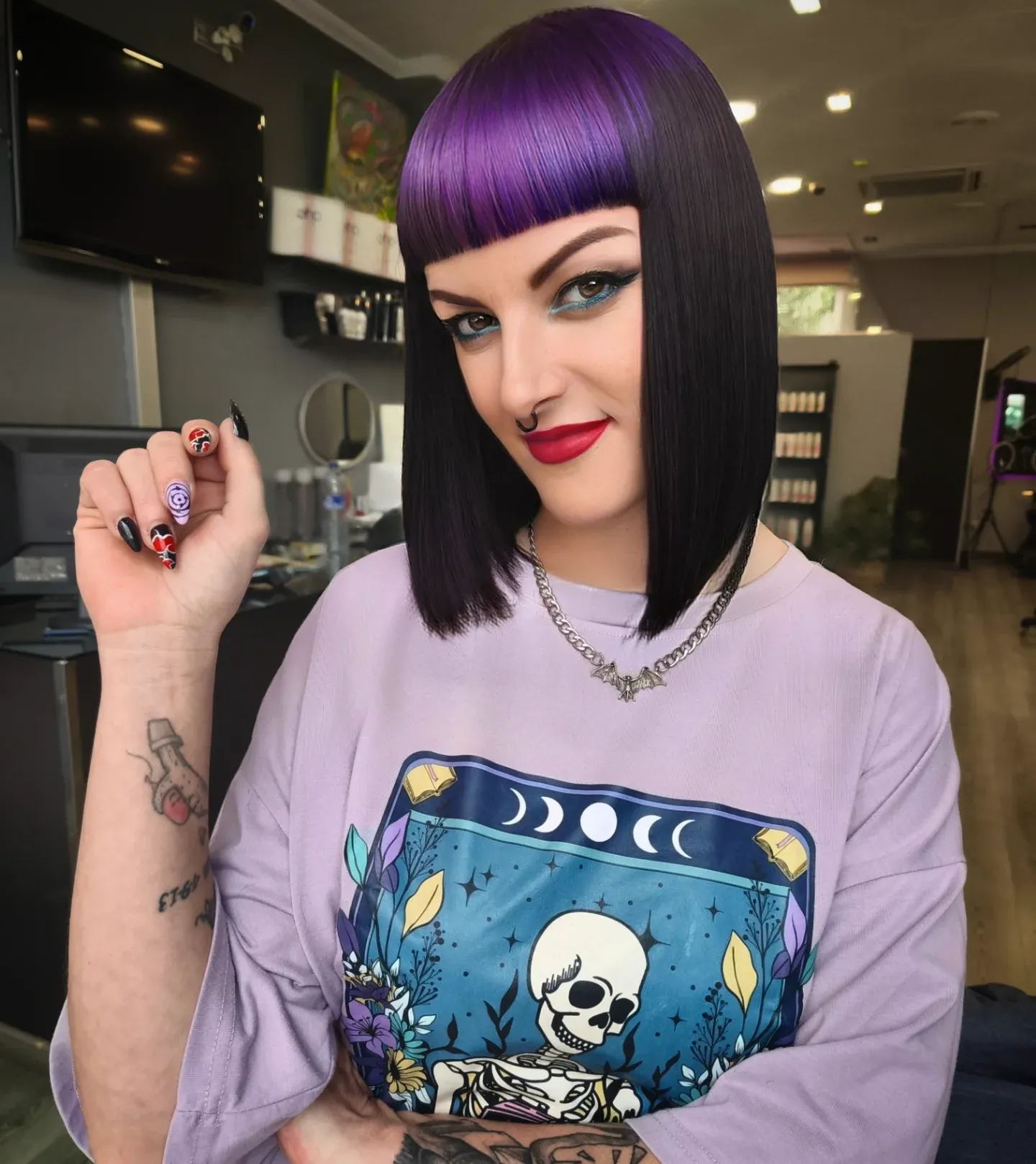 Purple A-line bob with straight micro fringe and long corners