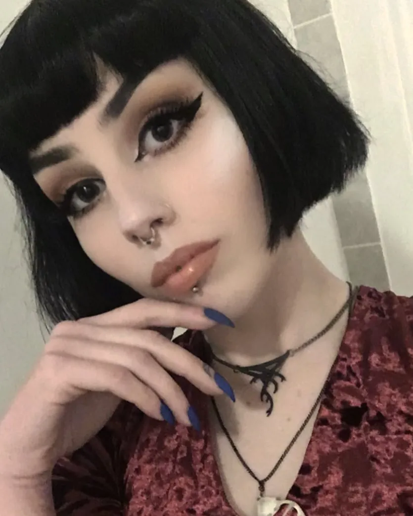 Short black micro bob with sculpted angular fringe