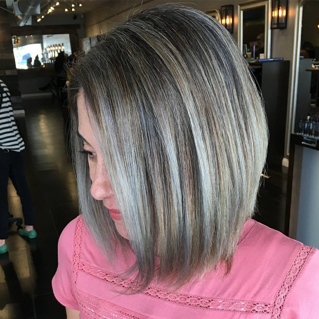 Highlighted gray angled long bob with a deep side part