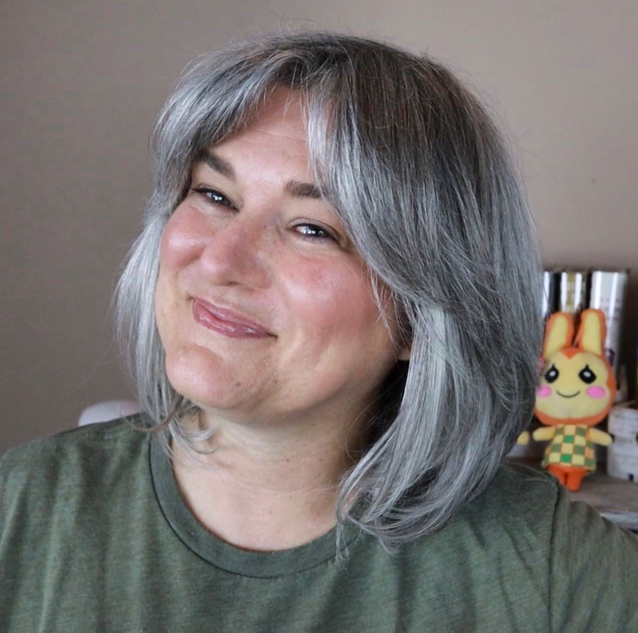 Layered gray bob with a full fringe and softly flicked ends