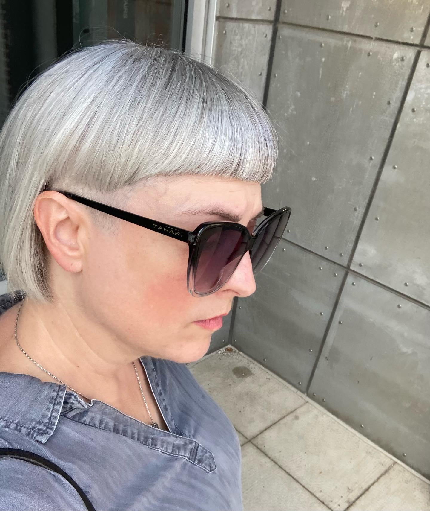 Rounded gray crop with a blunt fringe and closely cut sides