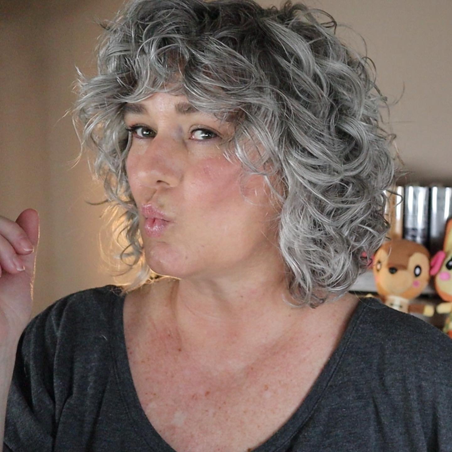 Curly gray bob with a full curly fringe and rounded shape