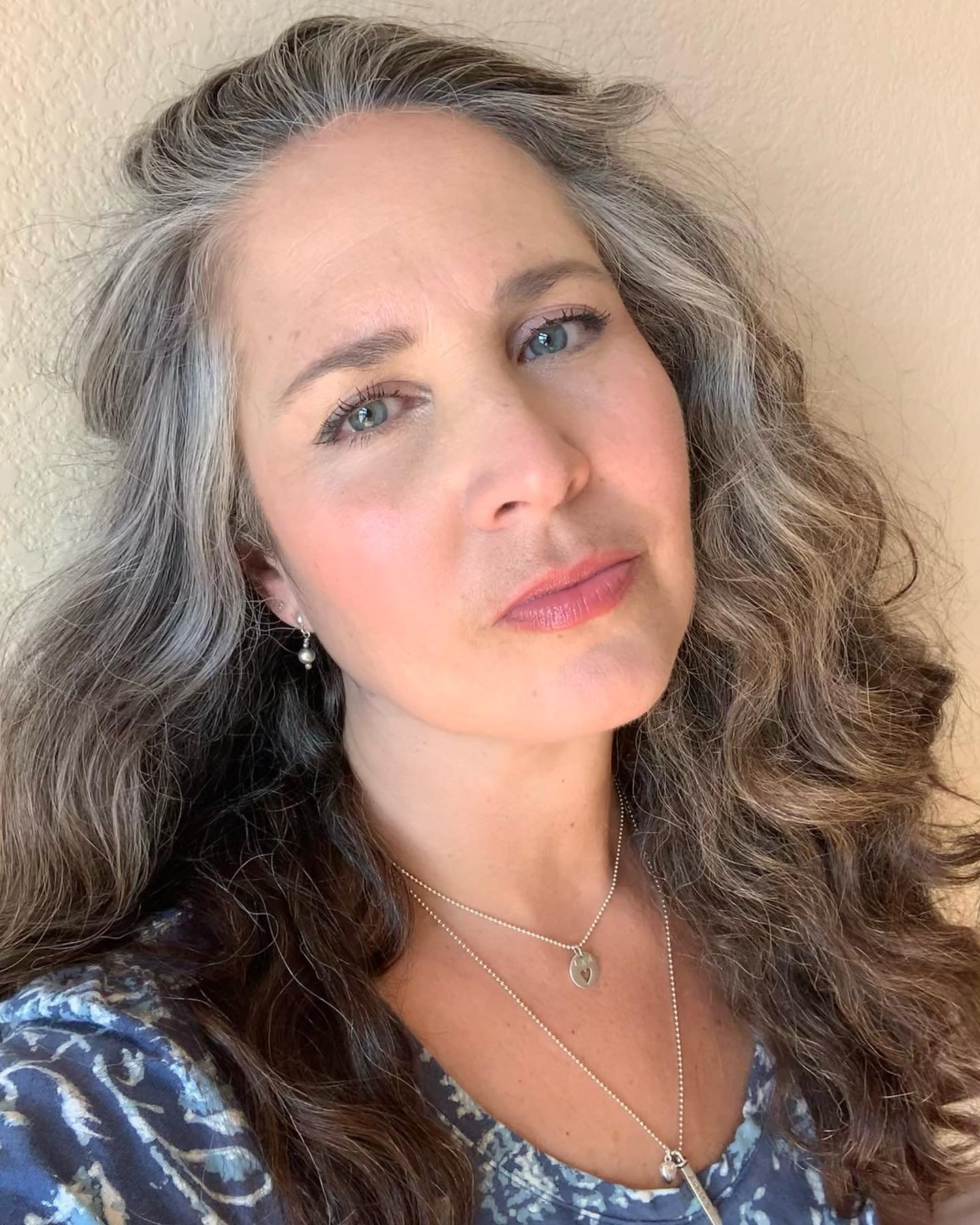 Long side-parted waves with naturally blended gray hair
