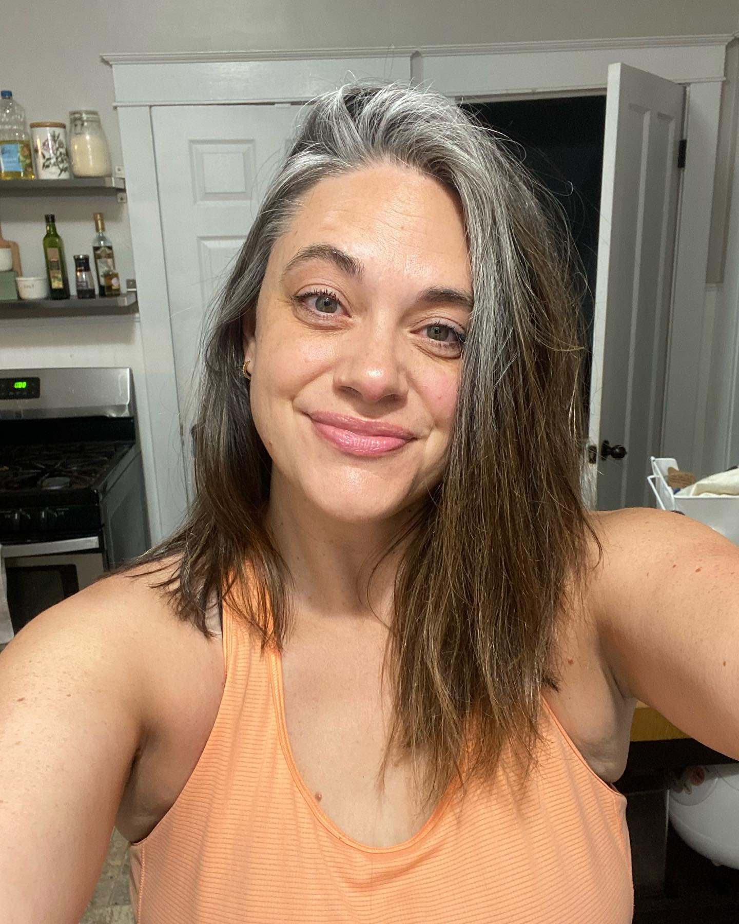 Straight shoulder-length cut with a gray front streak and side part