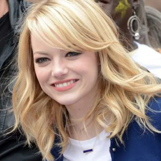 Layered blonde lob with side-swept fringe and flipped ends