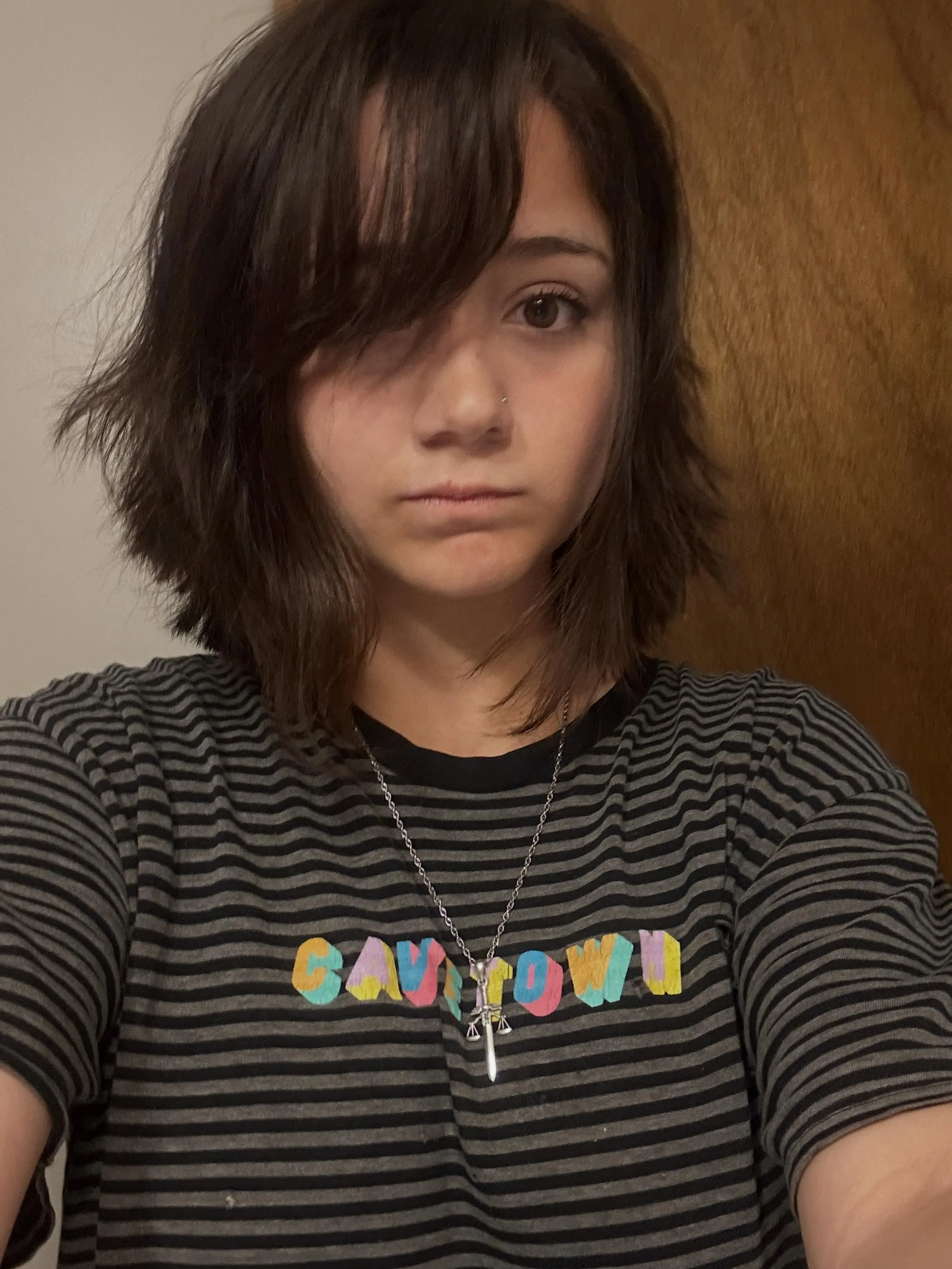 Choppy dark bob with long side fringe and flicked layers