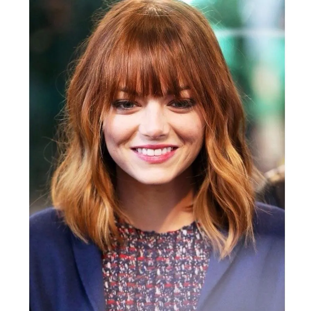 Wavy copper lob with a full fringe and softly layered ends