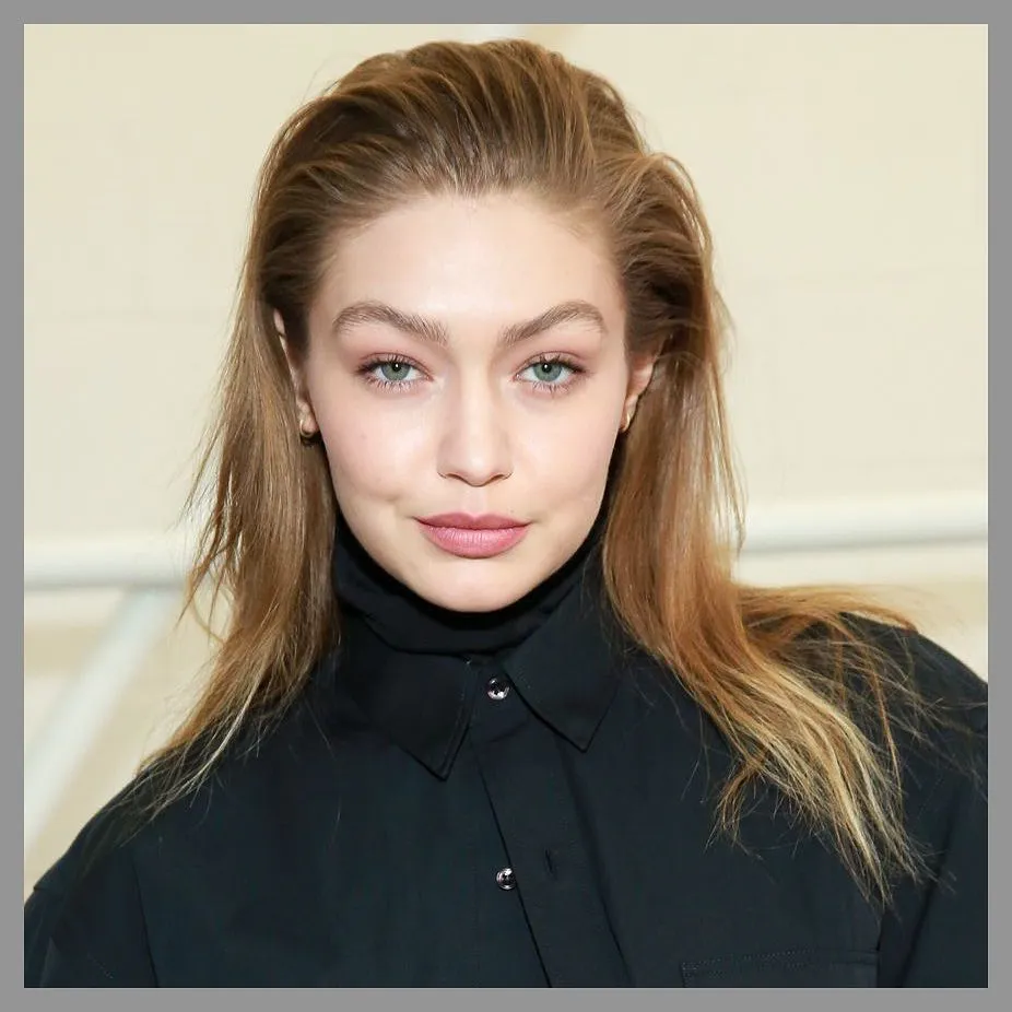 Long blonde layered hair slicked back with volume at the crown