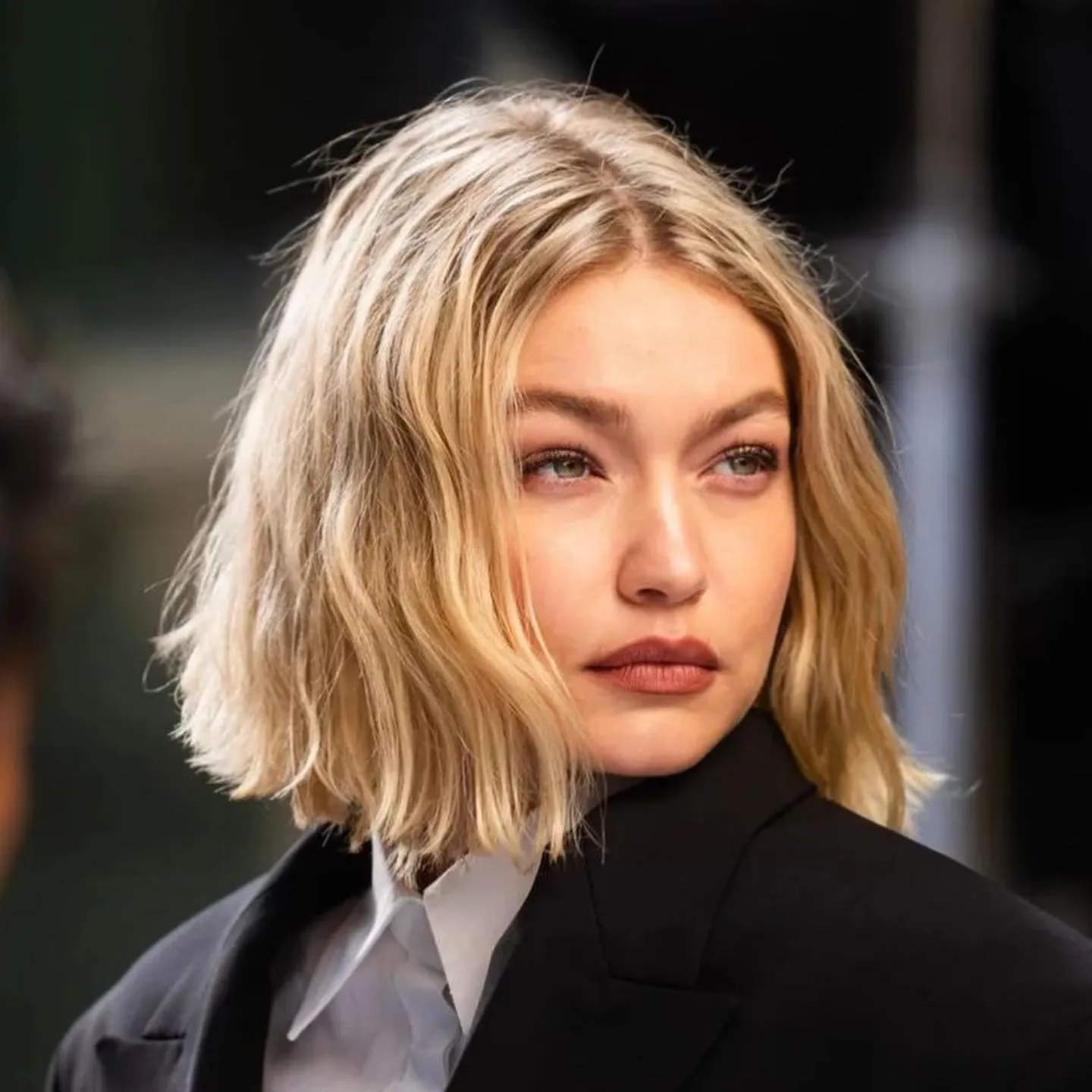 Tousled blonde blunt bob with a centre part and textured ends