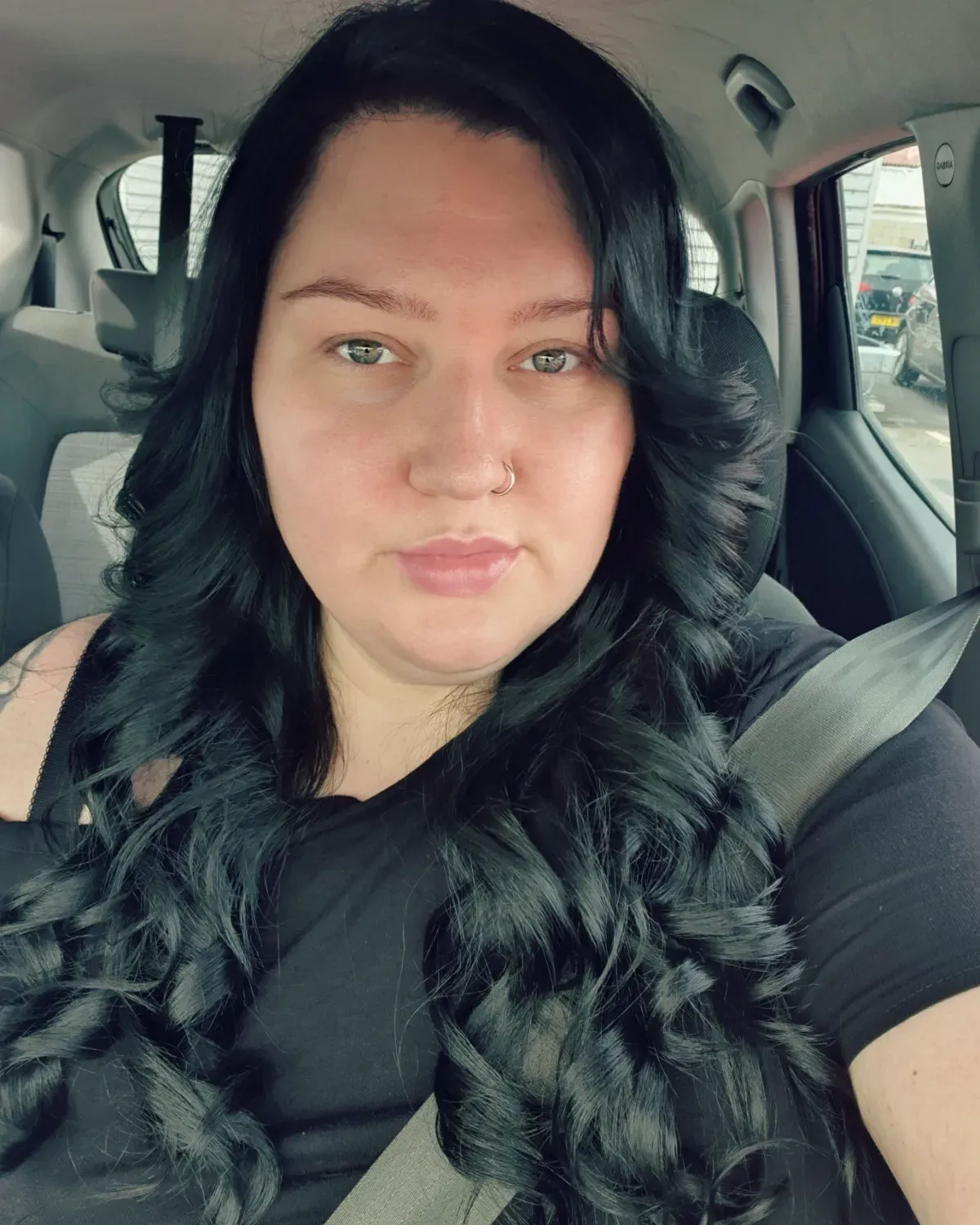 Long dark layered curls with a centre part and face-framing pieces