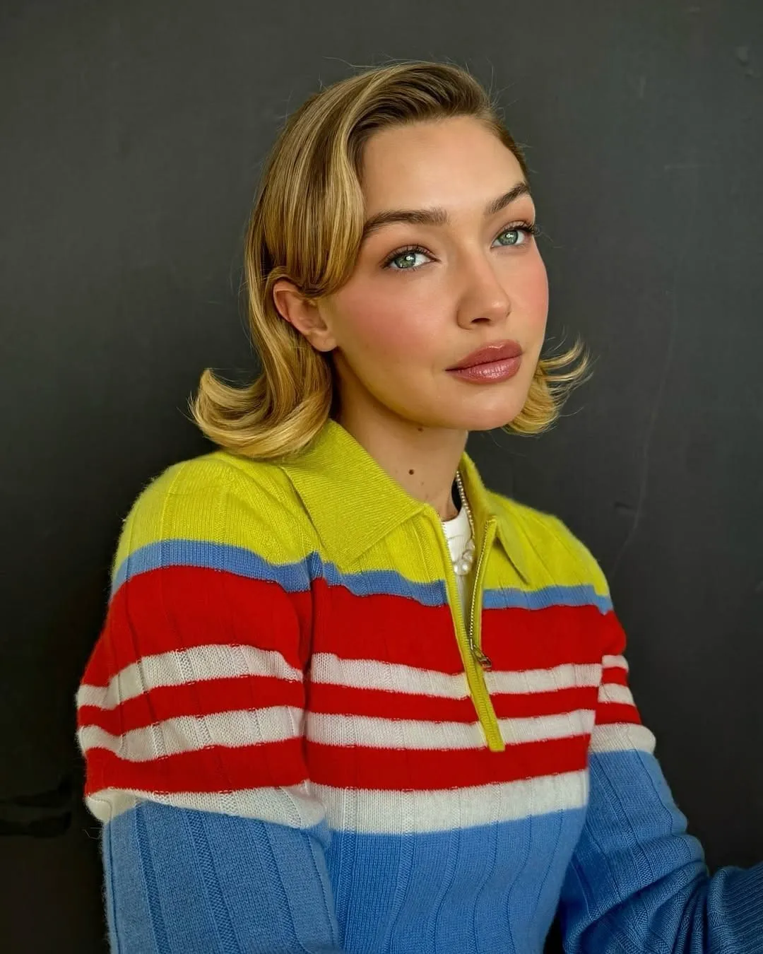 Retro blonde short bob with deep side part and flipped ends