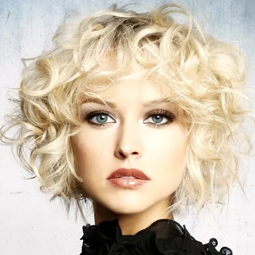 Voluminous blonde curly bob with a soft side part