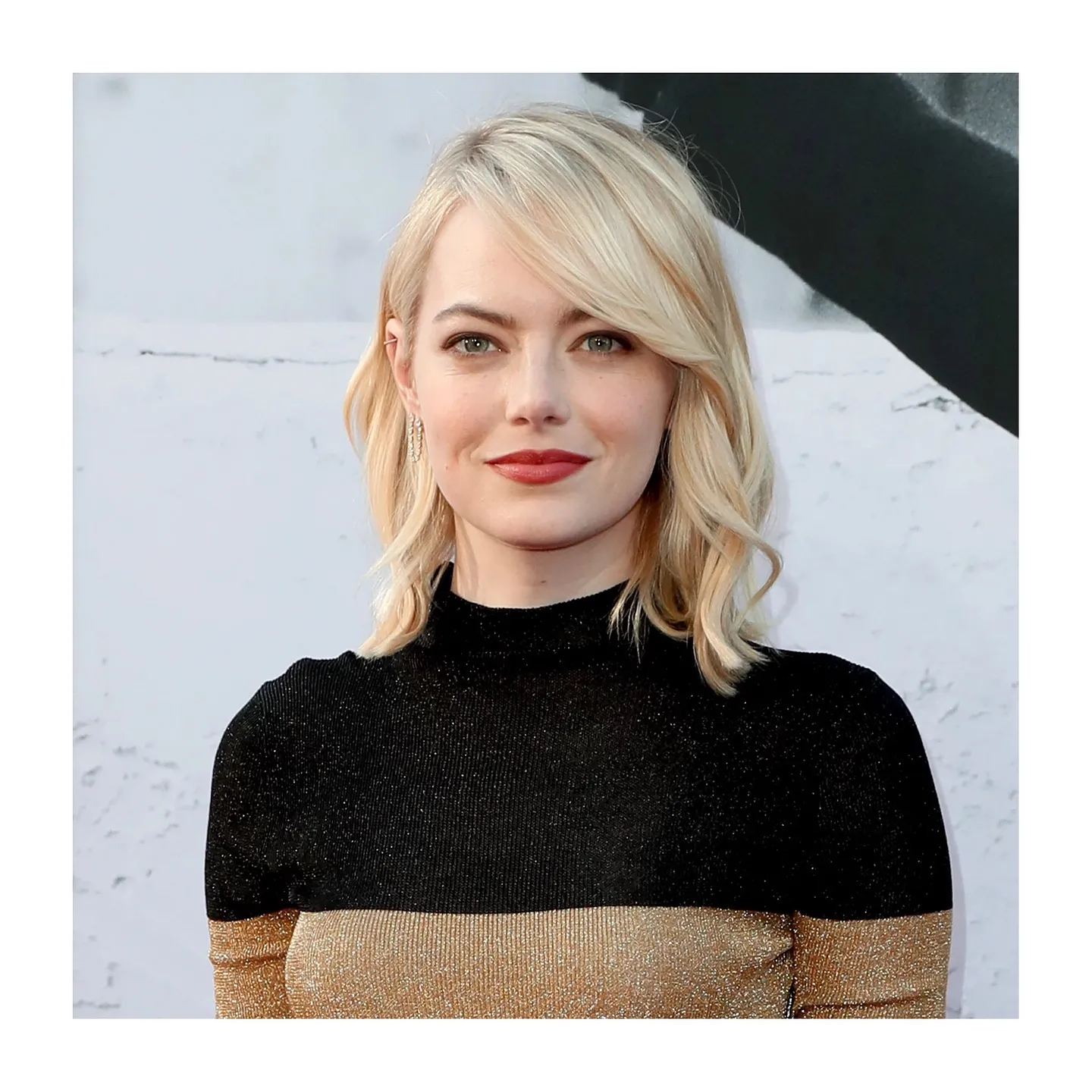 Shoulder-length blonde waves with a long side-swept fringe