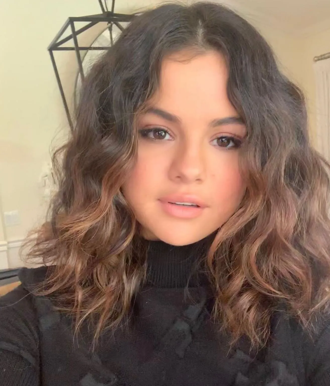 Layered curly lob with a centre part and soft face-framing curls