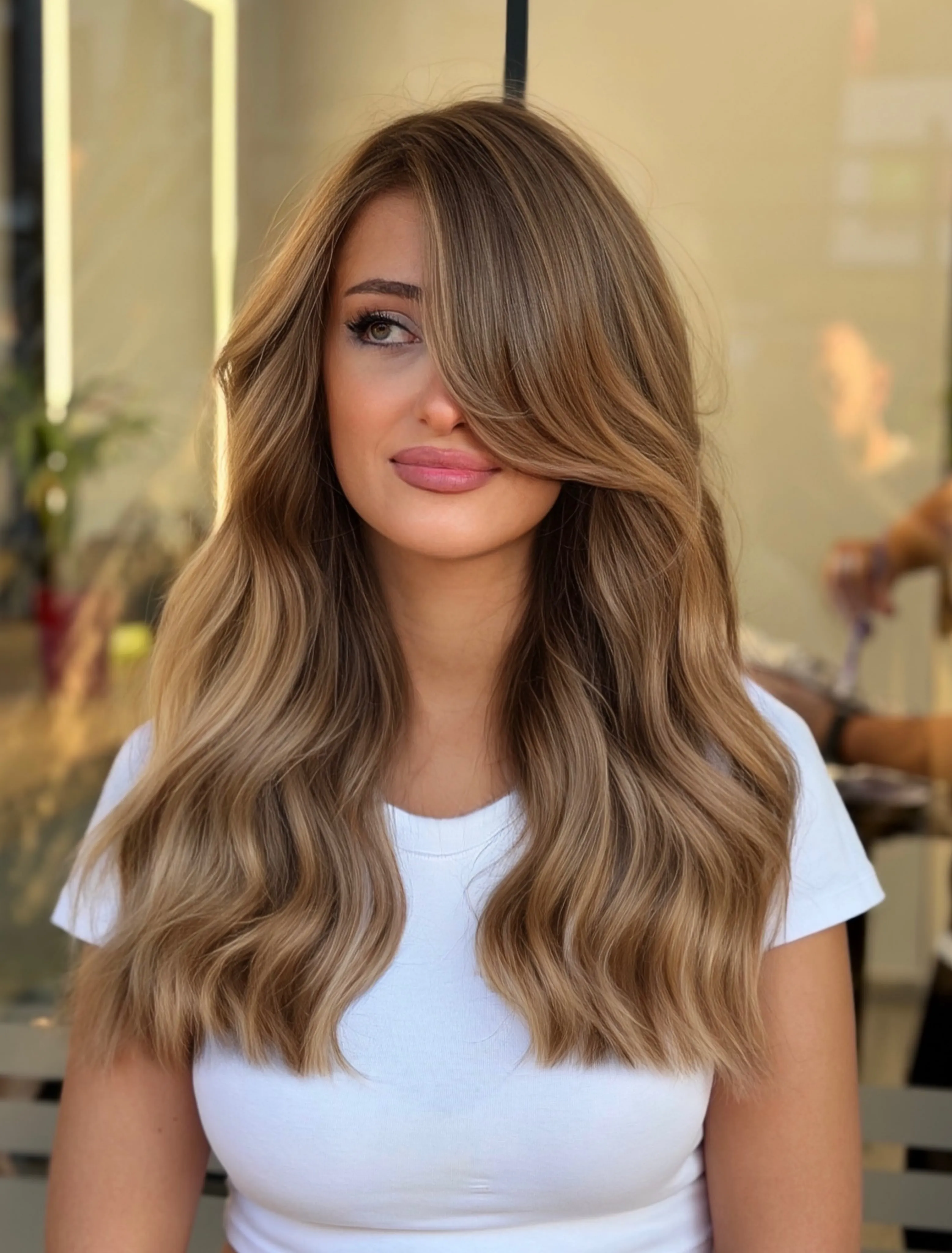 Long warm blonde hair with soft layered waves