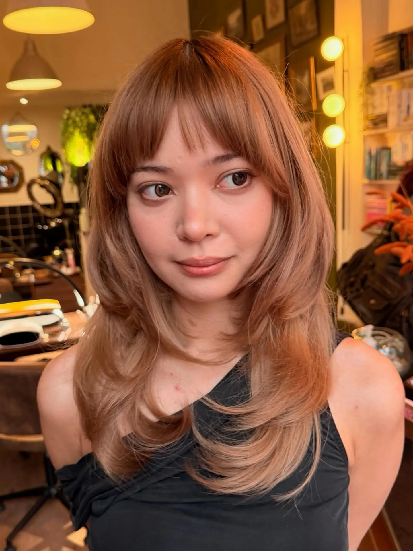 Layered shoulder-length cut with straight bangs