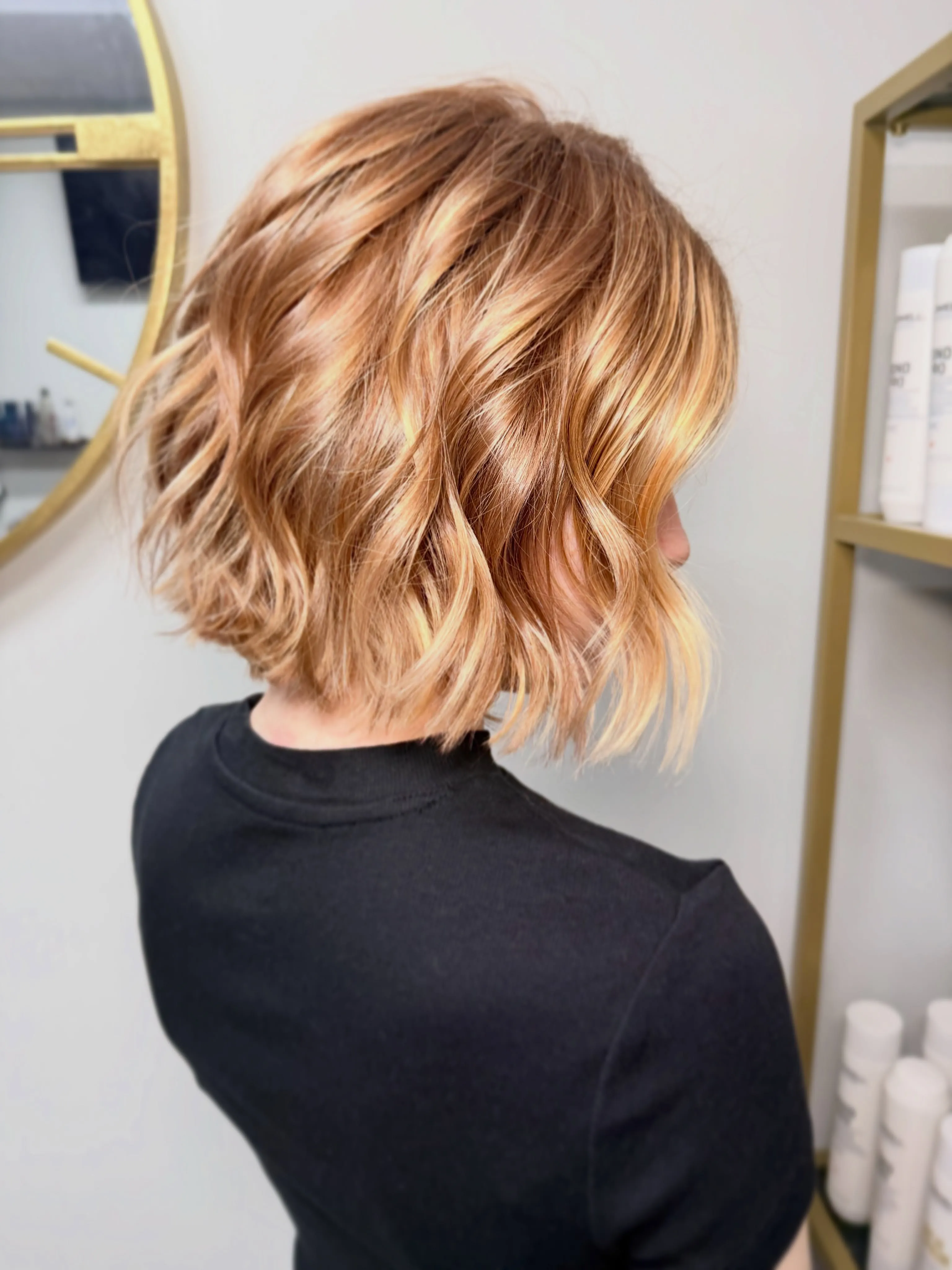 Tousled wavy blonde lob with darker roots