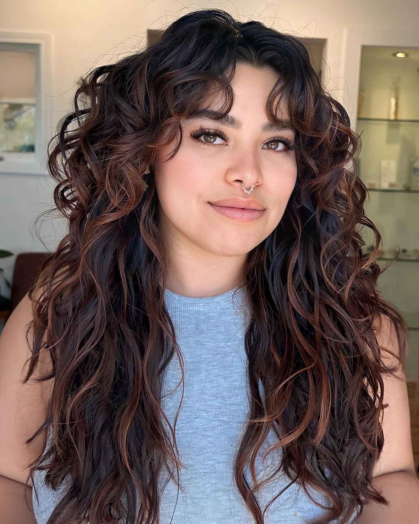 Long natural curls with warm ribbon highlights