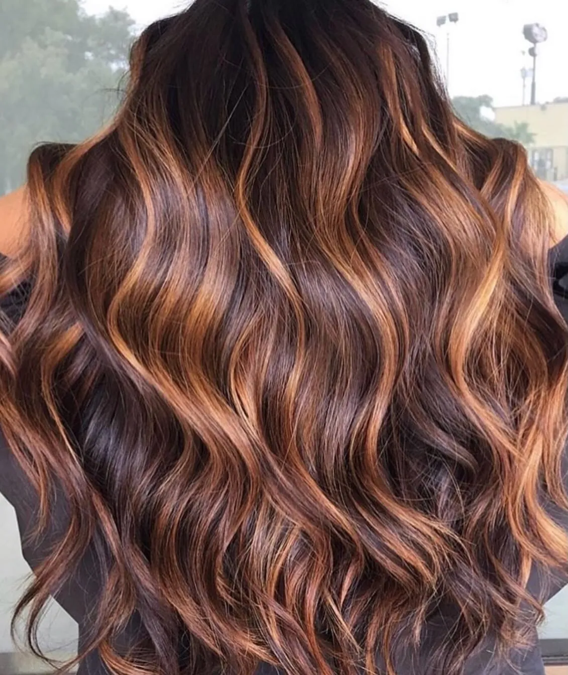 Long dark waves with warm copper-toned ribbons