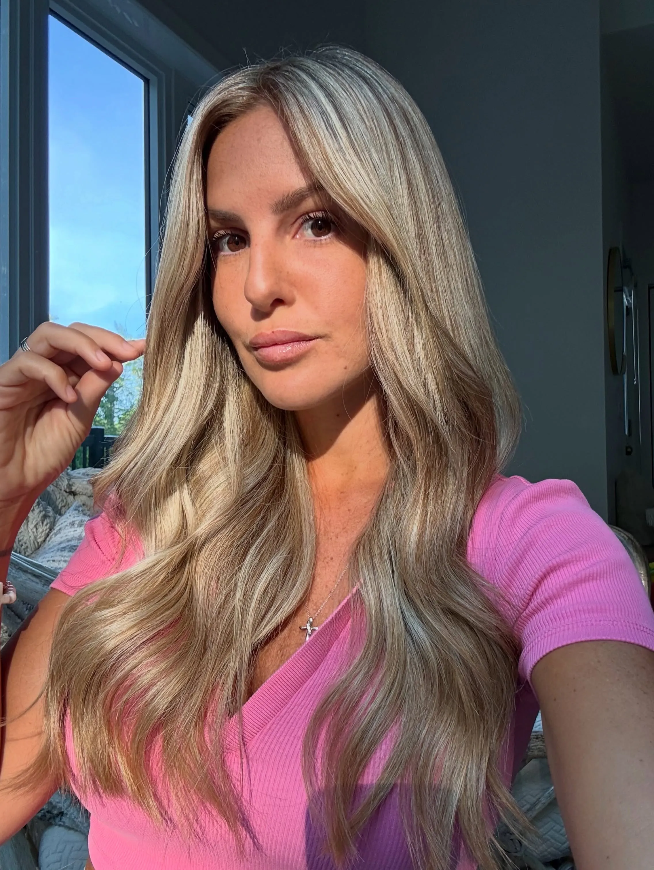 Long center-part blonde waves with bright face framing