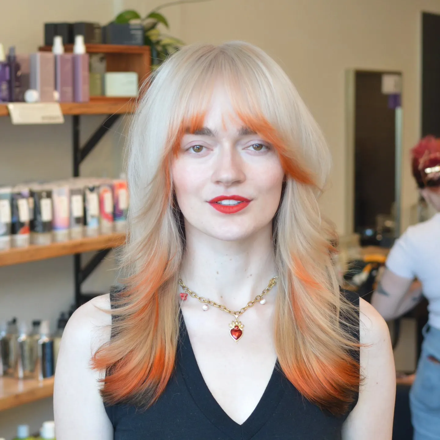 Layered shag haircut with full bangs and warm ends
