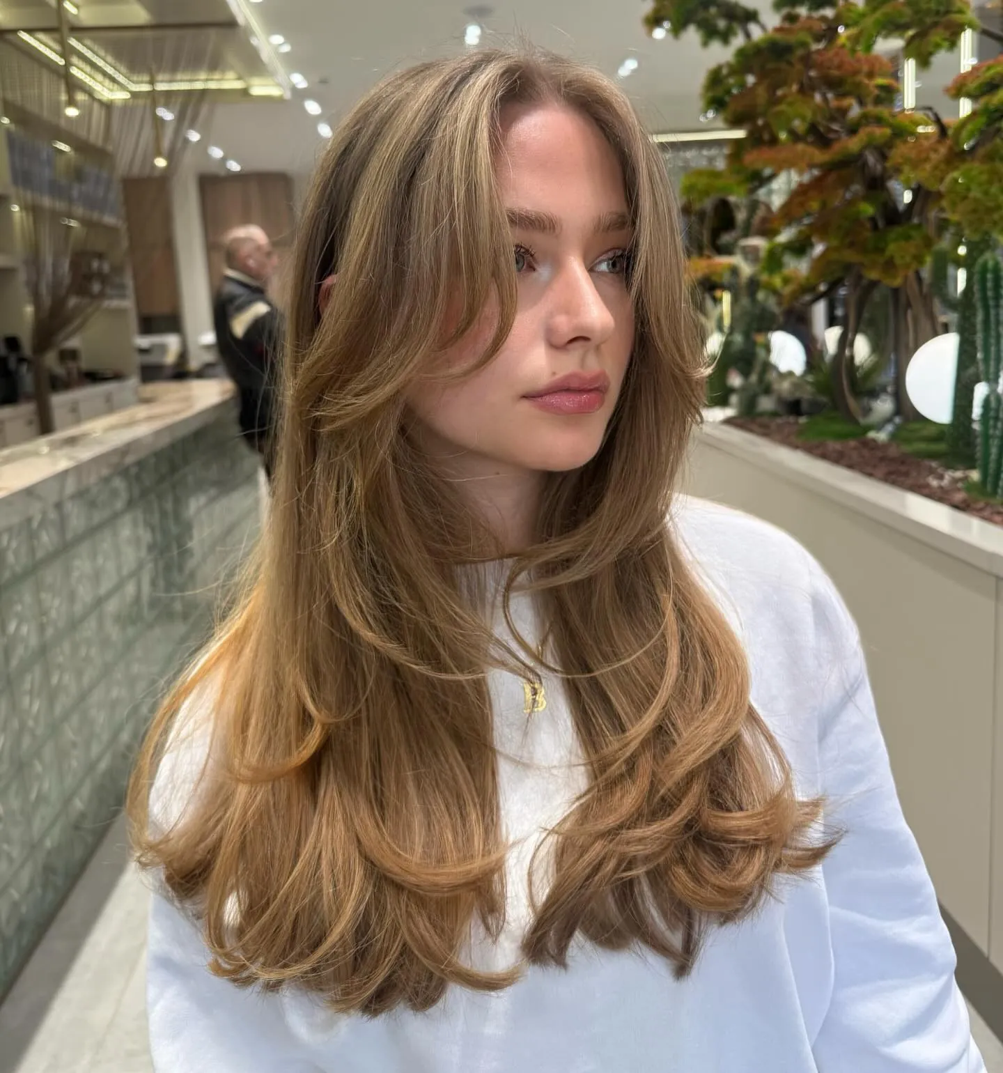 Long warm blonde blowout with layered ends