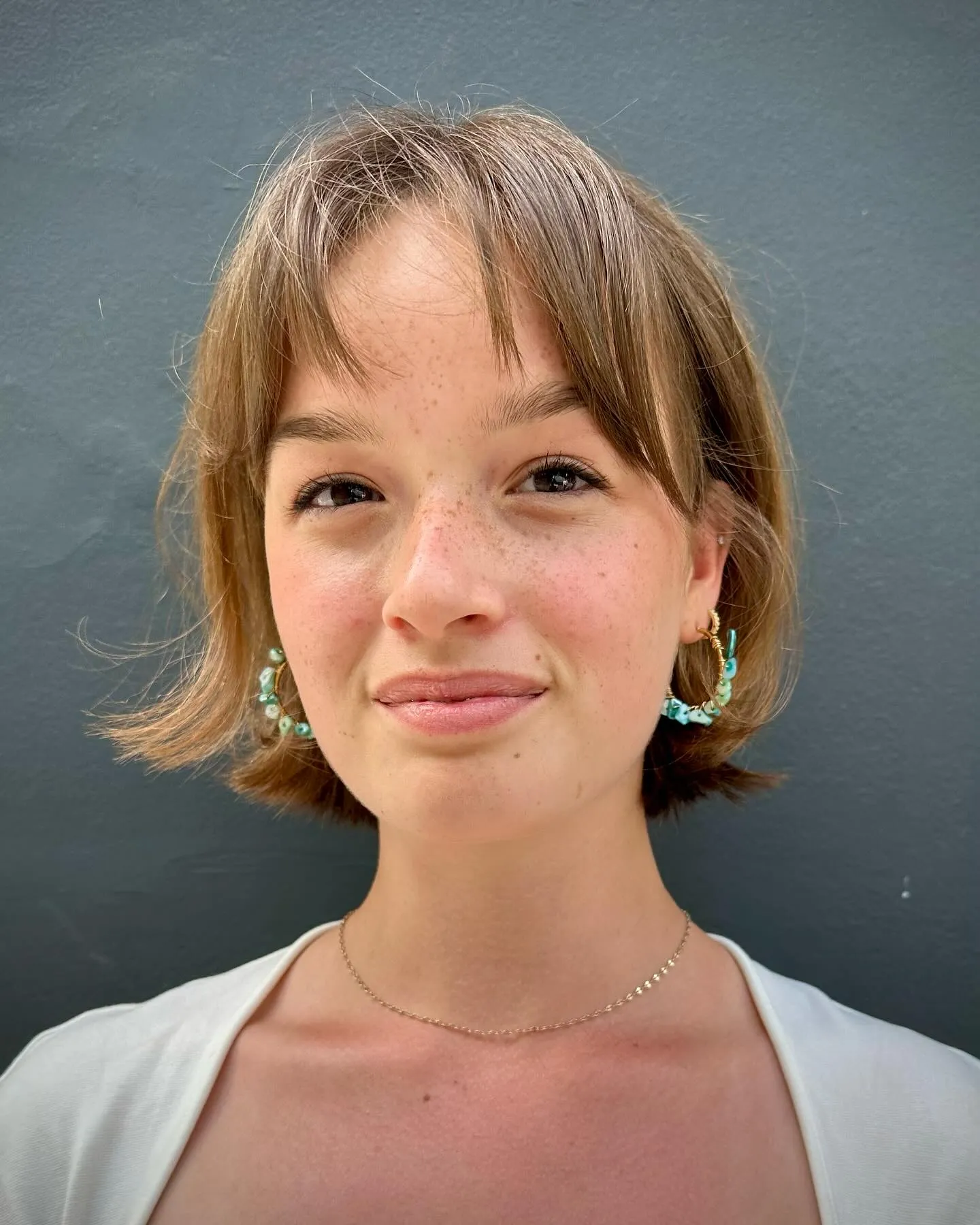Short flipped layered bob with wispy curtain bangs