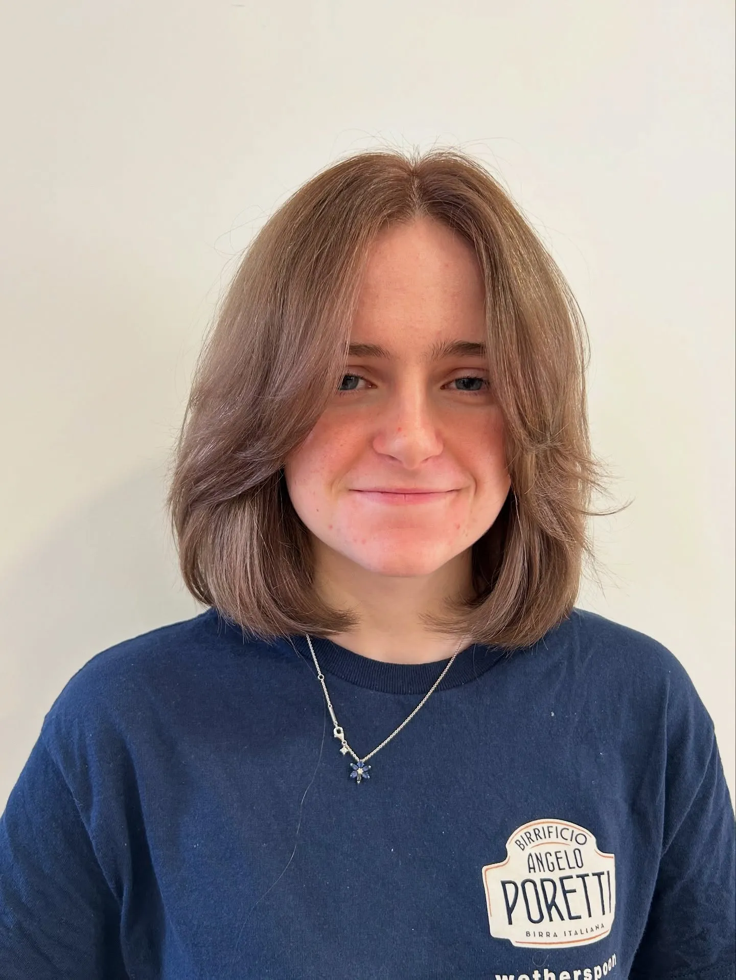 Shoulder-length layered bob with face-framing curtain bangs