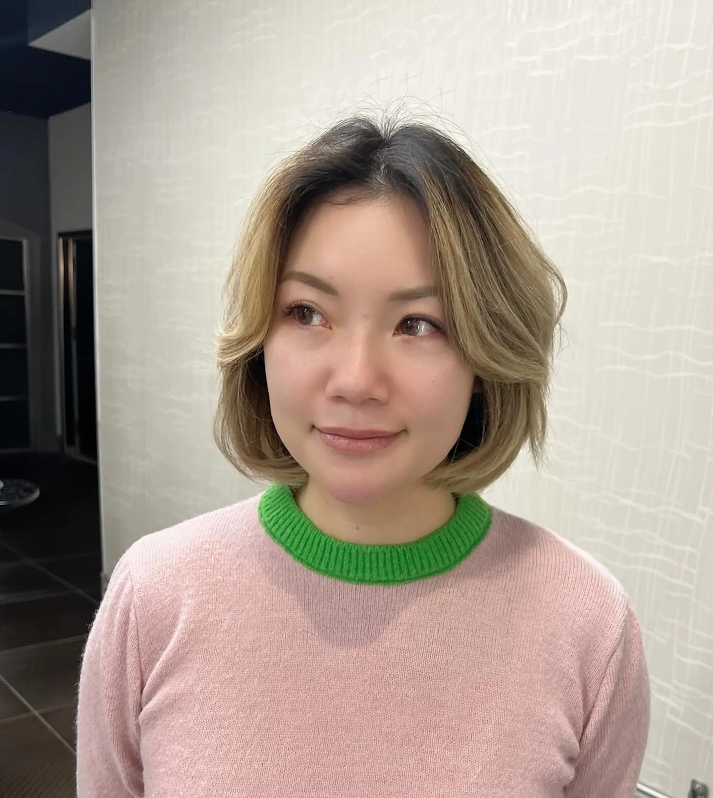 Sleek chin-length layered bob with long curtain bangs